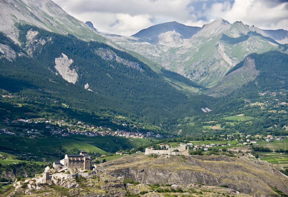 Alpine valley below rocky peaks